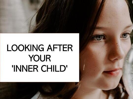 Young white woman with shoulder length dark hair holding a snow globe, just seen. Black upper case text in white text box reads: 'Looking after your 'inner child'.