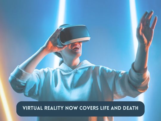 AI generated image of person in hoodie holding a virtual reality headset up to face, covering eyes, with other hand reaching out. Fluorescent blue lighting sparks in the background. Pale blue upper case text on blue pill shaped text box reads: Virtual reality now covers life and death.