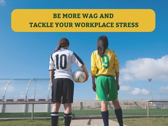 Image of two female footballers stood on the sidelines with their back to the camera, one in a black and white kit with number 10 on back of shirt, and another in yellow and green with number 9 on back of shirt. Green upper case text in a yellow text box reads: 'Be more WAG and tackle your workplace stress'